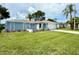 Classic one-story home offering a well-kept lawn, decorative landscaping, and an attached two-car garage at 7314 Ivanhoe Dr, Port Richey, FL 34668