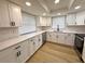Well-lit kitchen with stainless steel appliances, white cabinetry, and quartz countertops at 7314 Ivanhoe Dr, Port Richey, FL 34668