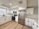 Bright kitchen features stainless steel appliances, white cabinets, and stylish countertops at 7314 Ivanhoe Dr, Port Richey, FL 34668