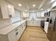 Bright kitchen featuring white cabinets, stainless steel appliances, and modern finishes at 7314 Ivanhoe Dr, Port Richey, FL 34668