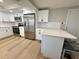 Updated kitchen with stainless steel appliances, white cabinets, and a breakfast bar at 7314 Ivanhoe Dr, Port Richey, FL 34668