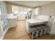 Stylish kitchen with white cabinetry, quartz countertops, and seating at the breakfast bar at 7314 Ivanhoe Dr, Port Richey, FL 34668