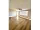 Bright living room with wood-look floors, a ceiling fan, and a window at 7314 Ivanhoe Dr, Port Richey, FL 34668