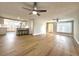 Open-concept living area with new flooring, a ceiling fan, and a kitchen view at 7314 Ivanhoe Dr, Port Richey, FL 34668