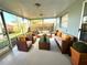 Relaxing screened-in patio featuring comfortable seating and ample natural light at 7314 Ivanhoe Dr, Port Richey, FL 34668