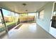 Relaxing screened porch with view of backyard and wood fence at 7314 Ivanhoe Dr, Port Richey, FL 34668