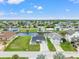 Aerial view showcasing the waterfront community with a canal network, lush lawns, and nearby conservation at 7401 Islander Ln, Hudson, FL 34667