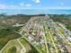 Aerial view showcasing the waterfront community's layout and location with canal access to the bay at 7401 Islander Ln, Hudson, FL 34667