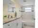 Bathroom featuring granite countertop, shower, and updated fixtures at 7401 Islander Ln, Hudson, FL 34667
