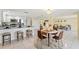 Open floor plan that features the kitchen with bar top and a dining table with 4 chairs at 7401 Islander Ln, Hudson, FL 34667