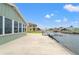 Waterfront home with a concrete patio, boat lift, and canal views at 7401 Islander Ln, Hudson, FL 34667