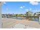 Property featuring a boat lift and private wooden dock for easy canal access, plus a large concrete patio at 7401 Islander Ln, Hudson, FL 34667