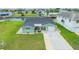 Inviting single-story home with a well-kept lawn and attached garage, located in a waterfront community at 7401 Islander Ln, Hudson, FL 34667