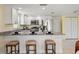 Bright kitchen with white cabinetry, stainless steel appliances, and granite countertops at 7401 Islander Ln, Hudson, FL 34667