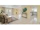 Open-concept living area with tile flooring and access to a bright kitchen at 7401 Islander Ln, Hudson, FL 34667