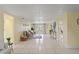 Spacious living room with white tile flooring and open floor plan, bright and airy at 7401 Islander Ln, Hudson, FL 34667