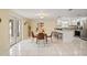 Open-concept living space with a dining area and modern kitchen with stainless appliances at 7401 Islander Ln, Hudson, FL 34667