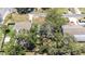 An aerial view of the home and neighborhood, featuring mature tree coverage, and proximity to neighbors at 7441 Cypress Dr, New Port Richey, FL 34653