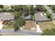 An aerial view of the home and neighborhood, featuring mature tree coverage, and proximity to neighbors at 7441 Cypress Dr, New Port Richey, FL 34653