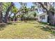 Lush backyard featuring mature trees and a grassy area at 7441 Cypress Dr, New Port Richey, FL 34653