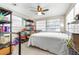 Bedroom featuring a bed, shelving units, and bright lighting at 7441 Cypress Dr, New Port Richey, FL 34653