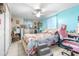 Bright bedroom featuring a floral bedspread, ceiling fan, and a vanity at 7441 Cypress Dr, New Port Richey, FL 34653
