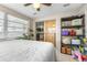 Bedroom showcasing a bed, shelving units, and tile flooring at 7441 Cypress Dr, New Port Richey, FL 34653