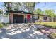 Cozy one story brick home with attached garage, mature trees, and unique decor at 7441 Cypress Dr, New Port Richey, FL 34653