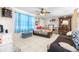 Inviting living room with tile floors, ceiling fan, and cozy seating at 7441 Cypress Dr, New Port Richey, FL 34653