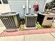 Exterior view of three modern AC units installed on concrete pads with brick trim at 8834 Whispering Oaks Trl, New Port Richey, FL 34654
