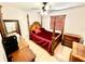 Traditional bedroom featuring a four-poster bed, ceiling fan, and antique wood furnishings at 8834 Whispering Oaks Trl, New Port Richey, FL 34654