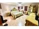 A beautifully decorated bedroom with ornate gold trim furniture and light wood flooring at 8834 Whispering Oaks Trl, New Port Richey, FL 34654