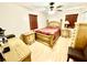 Comfortable bedroom with natural wood furnishings, a ceiling fan, and warm, inviting decor at 8834 Whispering Oaks Trl, New Port Richey, FL 34654