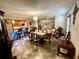 Bright dining room area with kitchen access, decorative rug and elegant dining set at 8834 Whispering Oaks Trl, New Port Richey, FL 34654