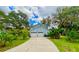 Charming home featuring a two car garage, and a well manicured lawn at 8834 Whispering Oaks Trl, New Port Richey, FL 34654