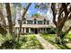 Beautiful house with a landscaped yard and traditional architectural elements at 8834 Whispering Oaks Trl, New Port Richey, FL 34654