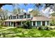 Charming two-story home featuring a well-manicured lawn and beautiful landscaping at 8834 Whispering Oaks Trl, New Port Richey, FL 34654