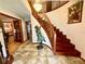 Elegant foyer featuring a curved staircase, chandelier, and tile flooring at 8834 Whispering Oaks Trl, New Port Richey, FL 34654