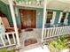 Inviting front porch with wooden door and blue siding at 8834 Whispering Oaks Trl, New Port Richey, FL 34654
