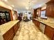 Modern kitchen with granite countertops and stainless steel appliances open to dining area at 8834 Whispering Oaks Trl, New Port Richey, FL 34654