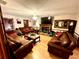 Comfortable living room with hardwood floors, brick fireplace, and stylish furnishings at 8834 Whispering Oaks Trl, New Port Richey, FL 34654