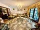 Formal living room featuring elegant furnishings, a chandelier, and tile flooring at 8834 Whispering Oaks Trl, New Port Richey, FL 34654