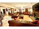 Large living room featuring hardwood floors, fireplace, and comfortable seating at 8834 Whispering Oaks Trl, New Port Richey, FL 34654