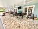 Comfortable covered patio with ceiling fans, entertainment area and outdoor furniture at 8834 Whispering Oaks Trl, New Port Richey, FL 34654