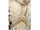 An updated walk-in shower featuring stone-look tiled walls and floor at 8834 Whispering Oaks Trl, New Port Richey, FL 34654