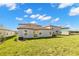 Well-maintained backyard with lush green grass and the back of the light grey home in the background at 8918 Parsons Hill Blvd, Wesley Chapel, FL 33545
