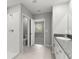Bathroom featuring a shower, toilet, and double sink vanity with tile flooring and granite countertops at 8918 Parsons Hill Blvd, Wesley Chapel, FL 33545