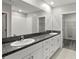 Bathroom showcasing double sinks with granite countertops, ample storage, and a walk-in shower at 8918 Parsons Hill Blvd, Wesley Chapel, FL 33545