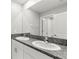 Bathroom with double sinks, granite counters, and a shower; providing a luxurious feel at 8918 Parsons Hill Blvd, Wesley Chapel, FL 33545