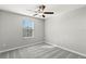This bedroom has gray carpet and a ceiling fan at 8918 Parsons Hill Blvd, Wesley Chapel, FL 33545